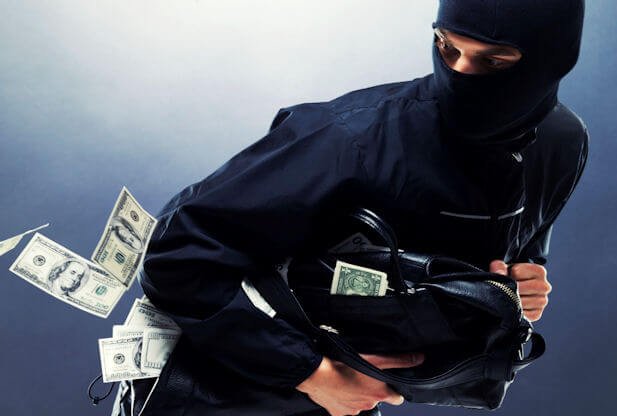 Masked robbers carrying bags of money in a casino