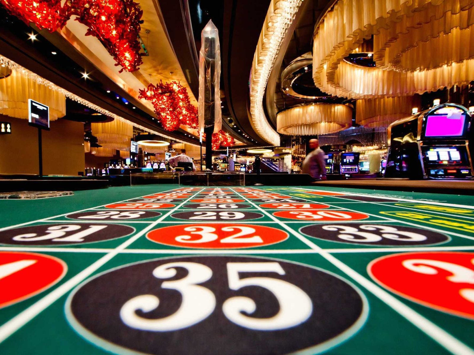 A darkened casino interior with rows of slot machines and colorful lights, symbolizing the allure and mystery of casino secrets.