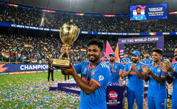 Sanju Samson smiling and holding the Player of the Tournament trophy in a packed stadium with Team India teammates cheering in the background during the T20 World Cup 2026 victory celebration.